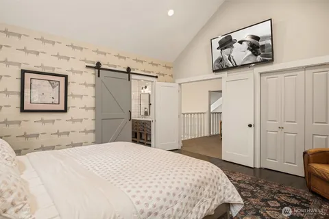 a bedroom with a large bed and a chandelier