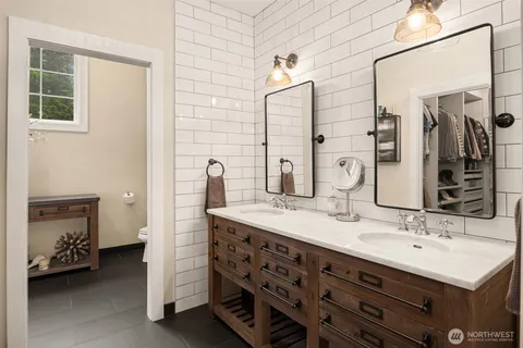 a bathroom with a sink double vanity and a mirror