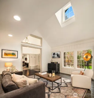 a living room with furniture and a floor to ceiling window
