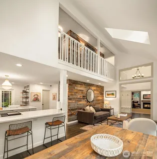 a living room with furniture a fireplace and a table