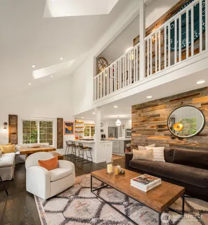 a living room with fireplace furniture and a table