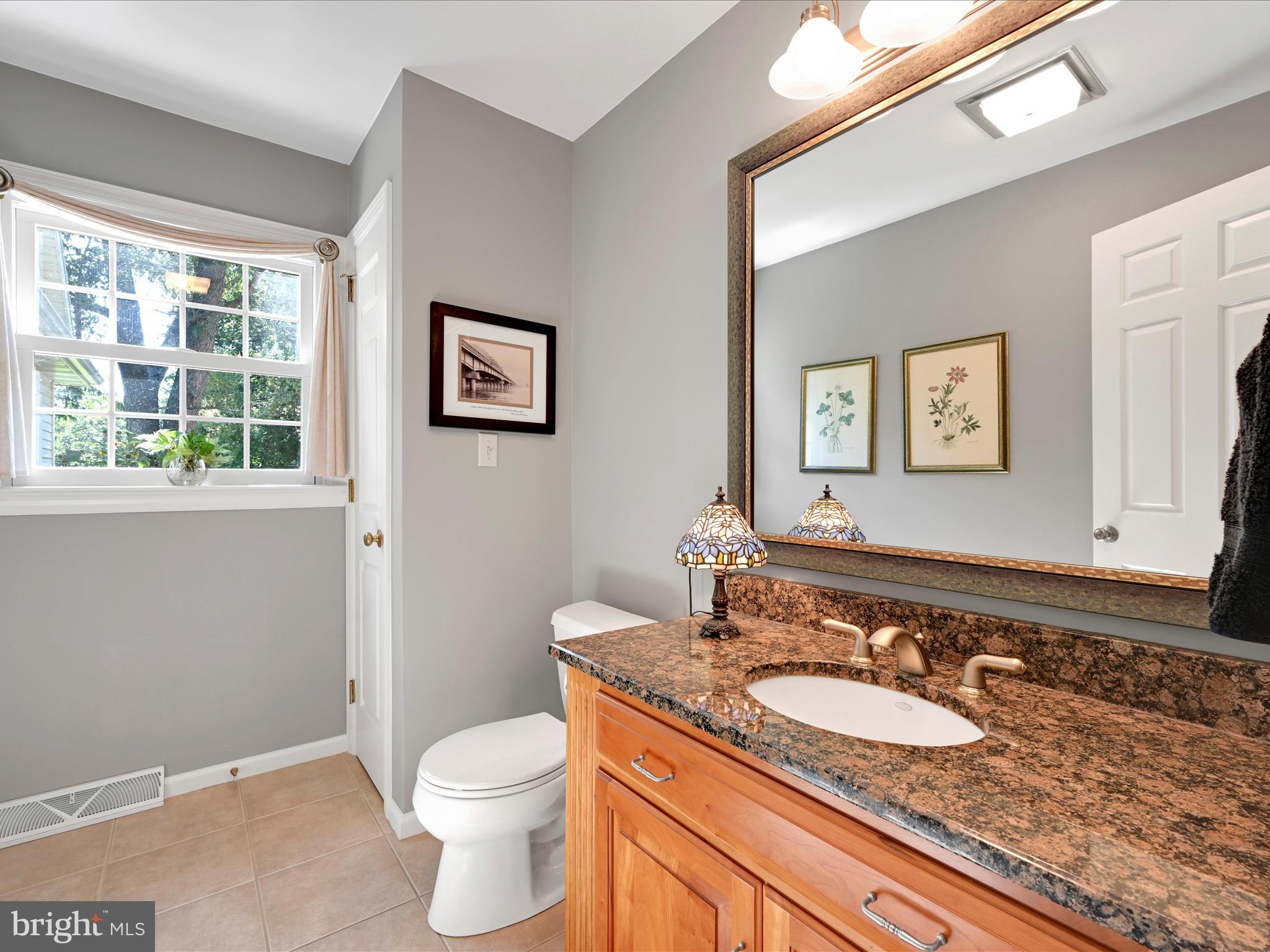 475 Sand Hill Road Pequea, PA 17565 - Photo 23 of 54 a bathroom with a granite countertop toilet sink and mirror