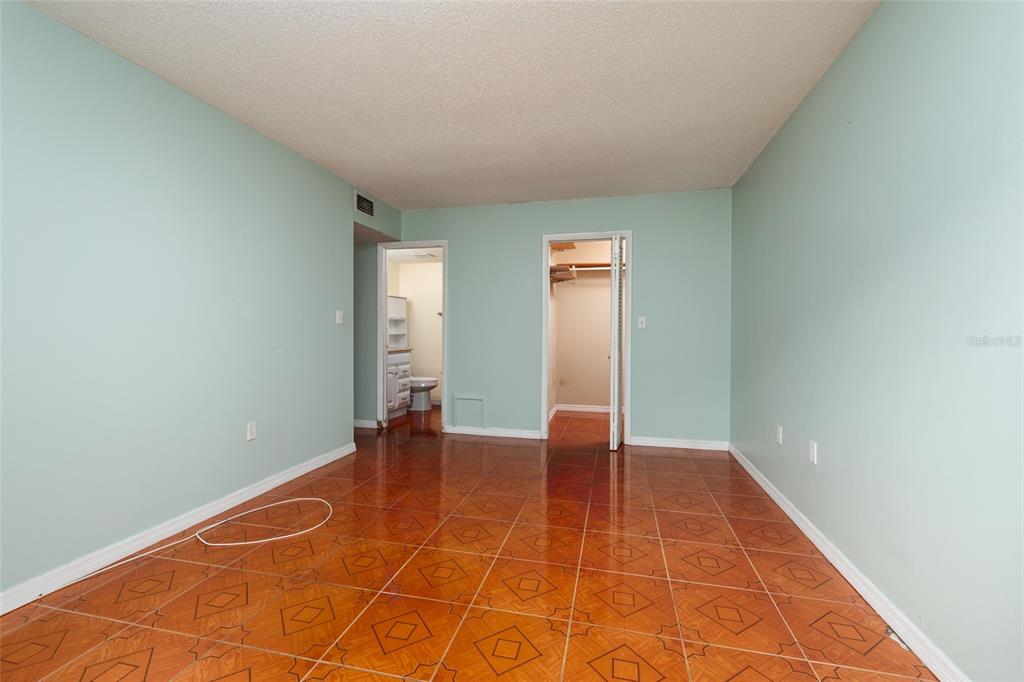 5409 Orange Blossom Road Pinellas Park, FL 33782 - Photo 13 of 30 an empty room with wooden floor and windows