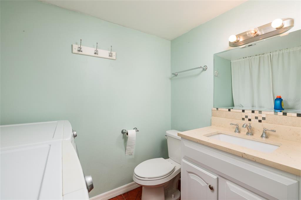 5409 Orange Blossom Road Pinellas Park, FL 33782 - Photo 15 of 30 a bathroom with a sink a toilet and a mirror