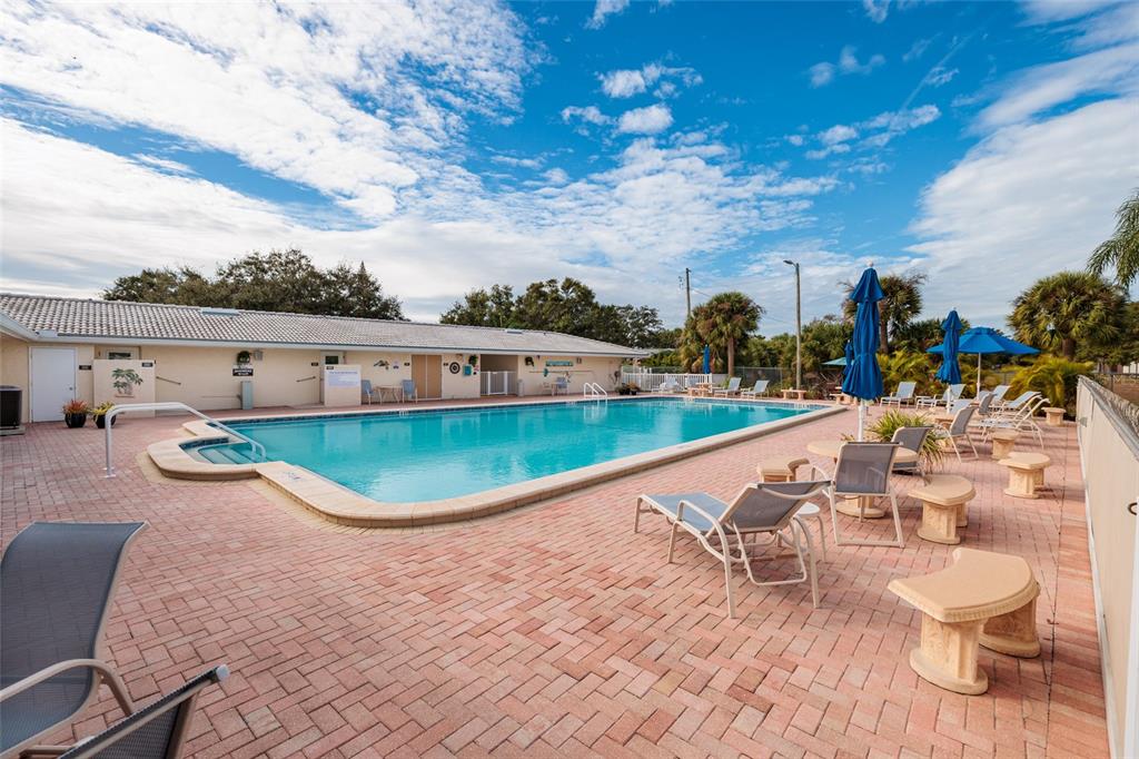5409 Orange Blossom Road Pinellas Park, FL 33782 - Photo 25 of 30 a view of a swimming pool with a lounge chairs