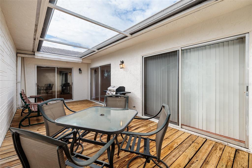 5409 Orange Blossom Road Pinellas Park, FL 33782 - Photo 3 of 30 a view of a dining room with furniture and wooden floor