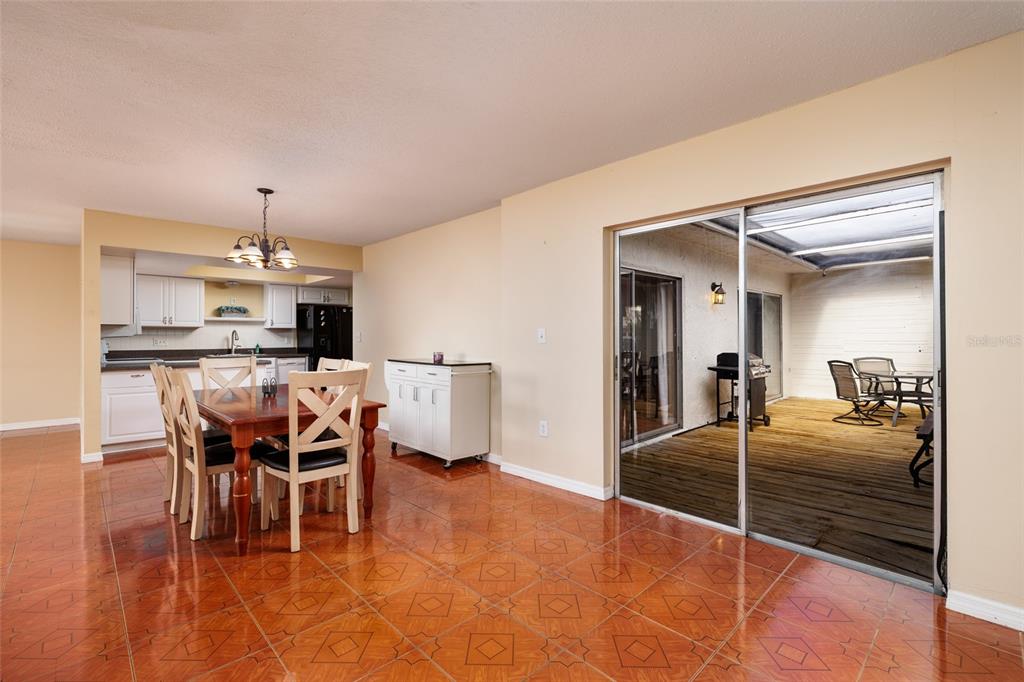 5409 Orange Blossom Road Pinellas Park, FL 33782 - Photo 6 of 30 a dining room with furniture and a chandelier
