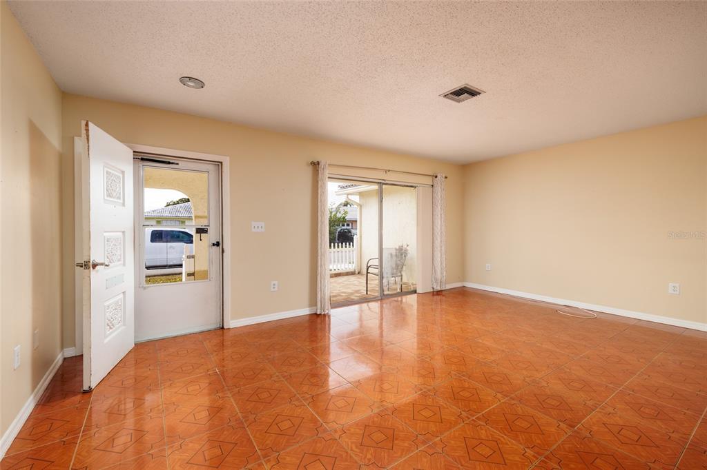 5409 Orange Blossom Road Pinellas Park, FL 33782 - Photo 8 of 30 a view of an empty room with wooden floor and a window