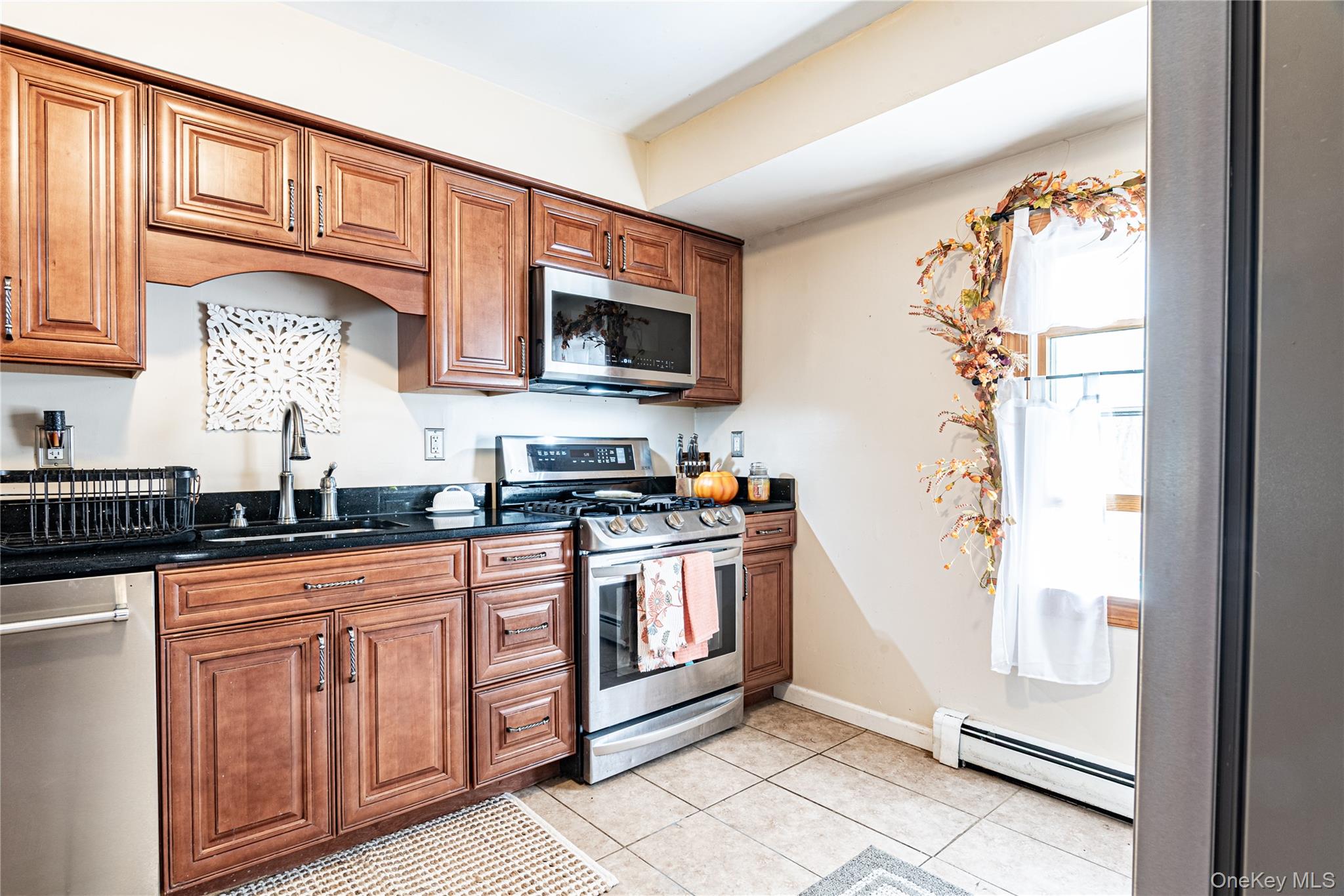 32 Deer Run Road Poughkeepsie, NY 12603 - Photo 15 of 30 a kitchen with stainless steel appliances granite countertop a stove a sink and a microwave