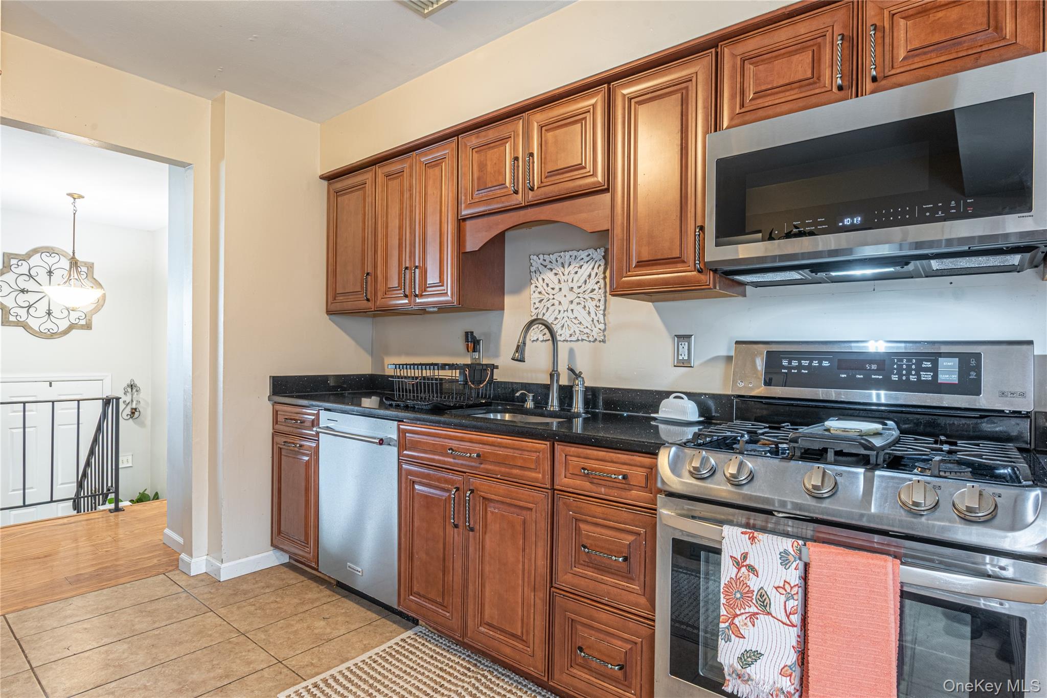 32 Deer Run Road Poughkeepsie, NY 12603 - Photo 16 of 30 a kitchen with stainless steel appliances wooden cabinets and a stove top oven