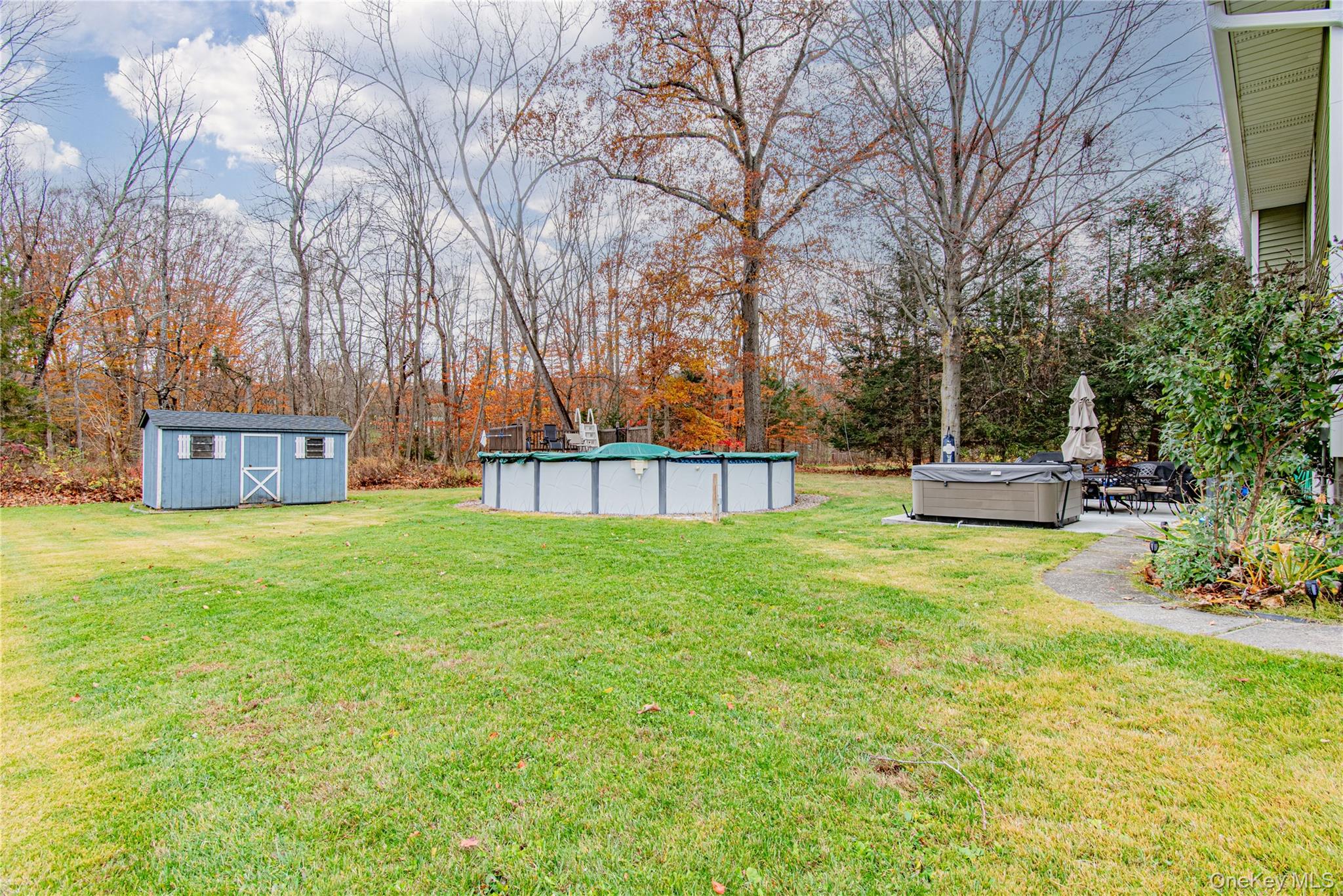 32 Deer Run Road Poughkeepsie, NY 12603 - Photo 4 of 30 a front view of a house with garden and sitting area