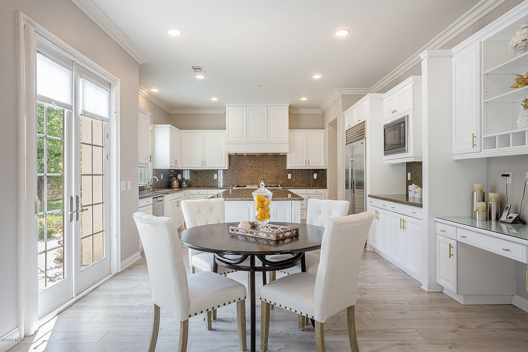 2734 Forest Grove Lane Simi Valley, CA 93065 - Photo 20 of 57 a kitchen with a dining table chairs refrigerator and cabinets