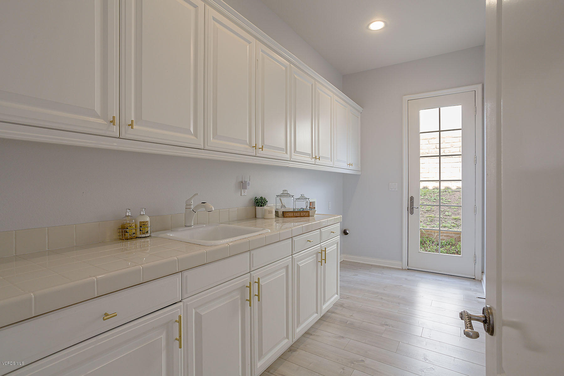 2734 Forest Grove Lane Simi Valley, CA 93065 - Photo 24 of 57 a kitchen with stainless steel appliances granite countertop a sink and dishwasher with white cabinets