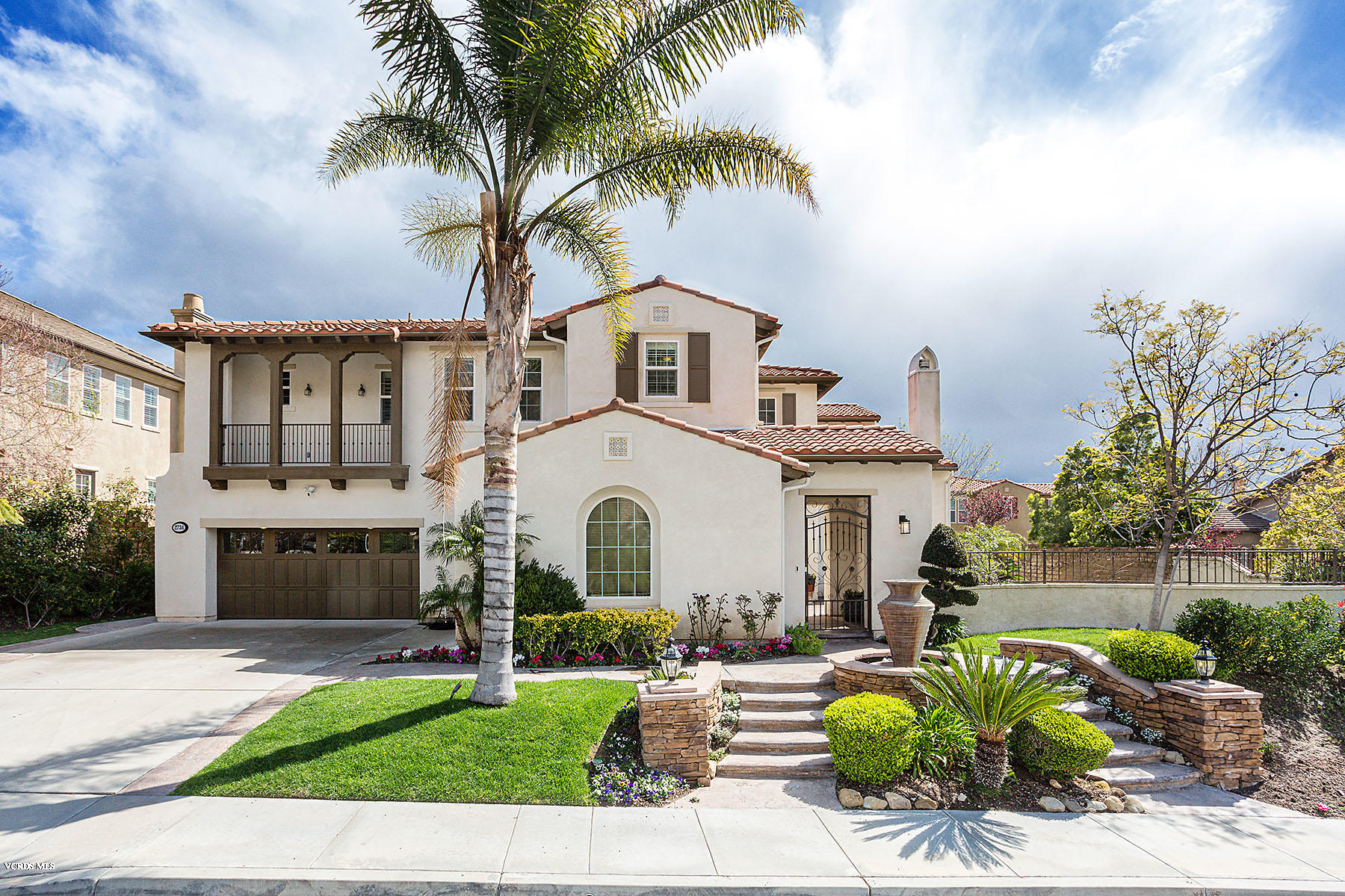 2734 Forest Grove Lane Simi Valley, CA 93065 - Photo 4 of 57 a front view of a house with a garden and outdoor seating