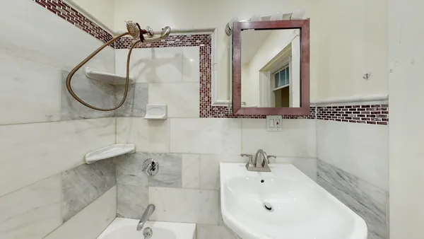 a bathroom with a sink a toilet and mirror