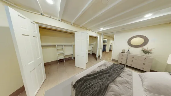 a bedroom with a bed and cabinets