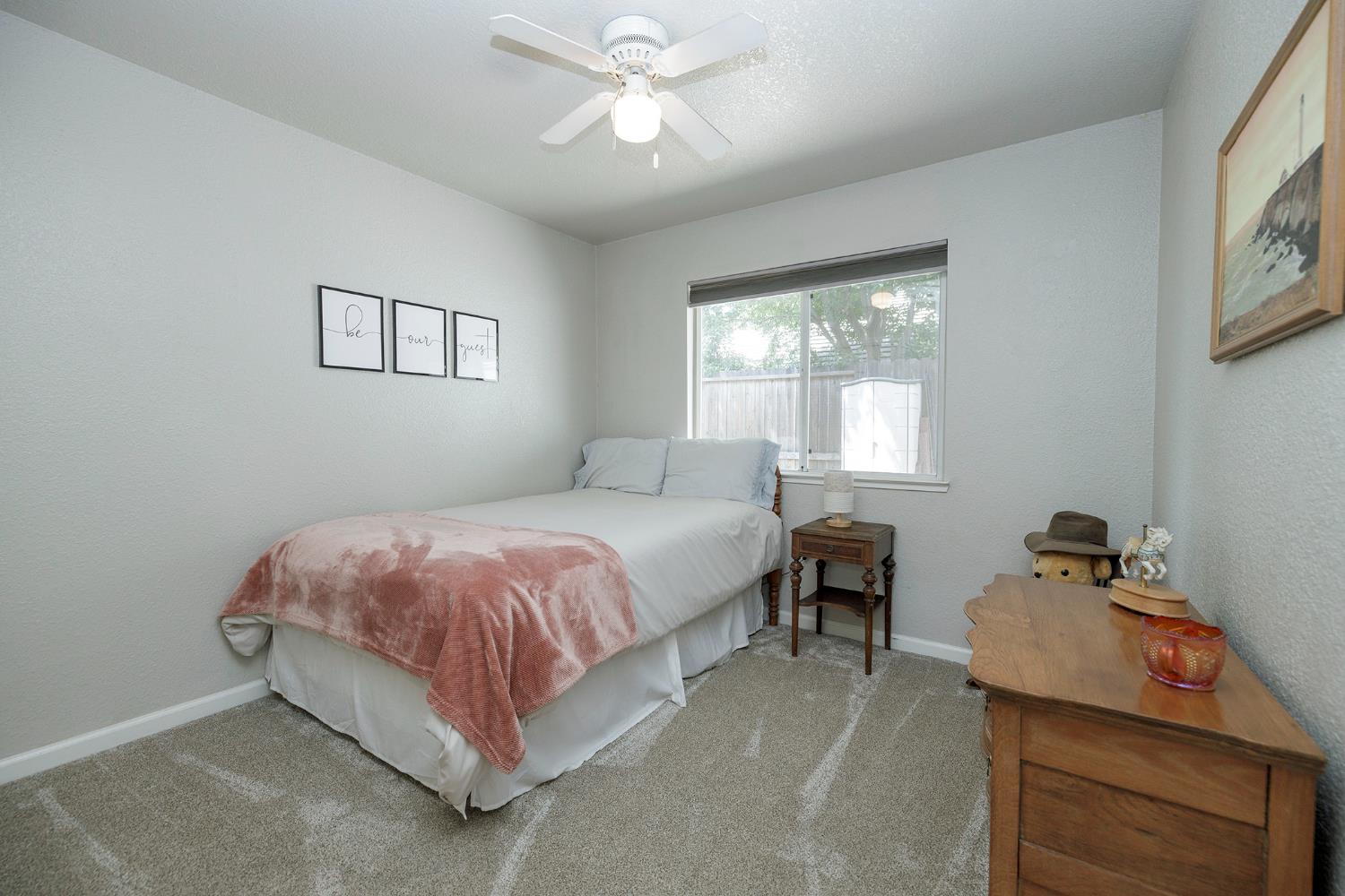 230 Meyenberg Avenue Ripon, CA 95366 - Photo 38 of 52 a spacious bedroom with a bed and window