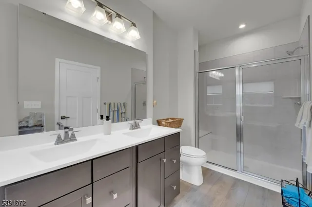 a bathroom with a sink double vanity and a shower