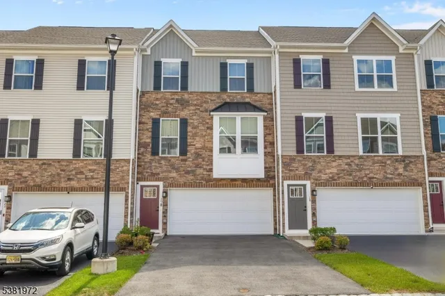 a front view of a house with parking space