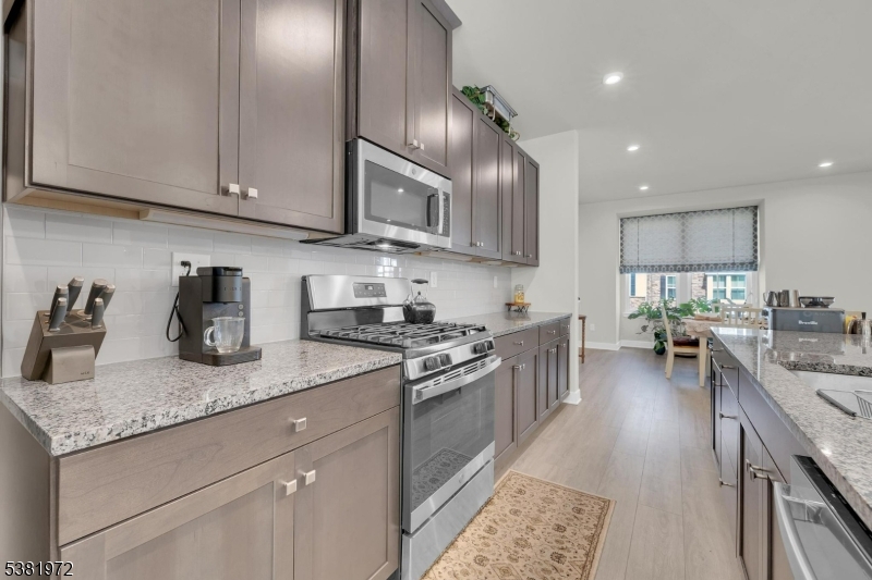 20 Peckwell Street Budd Lake, NJ 07828 - Photo 10 of 39 a kitchen with granite countertop stainless steel appliances sink stove top oven and cabinets