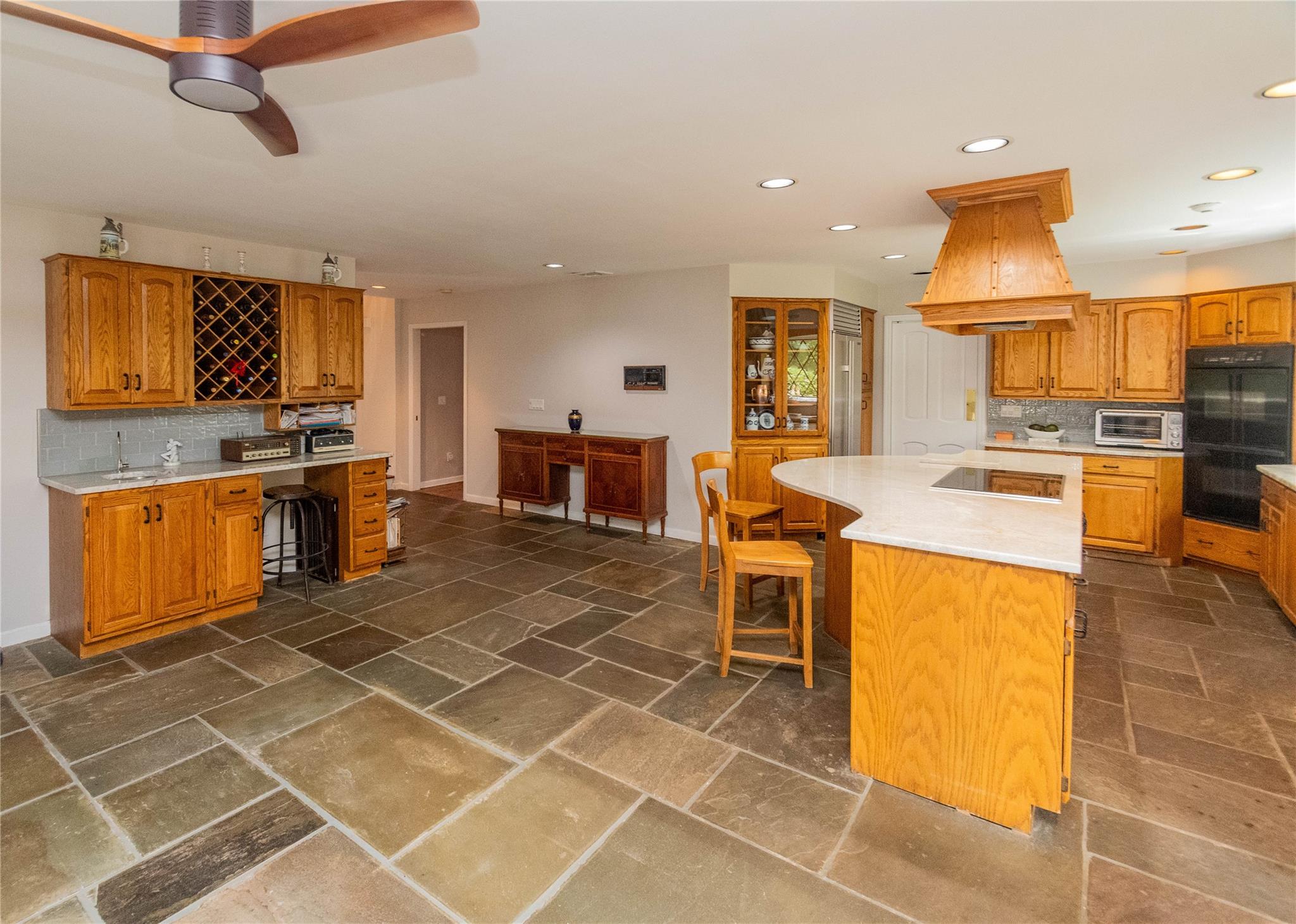 7 Fox Hollow Road Brewster, NY 10509 - Photo 12 of 33 a kitchen with stainless steel appliances a stove a sink cabinets and living room view