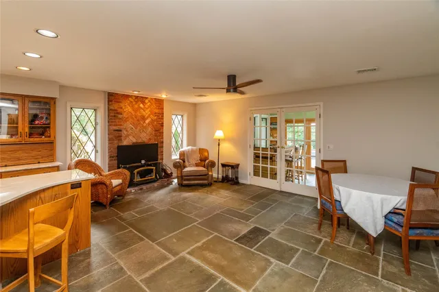 a living room with furniture a flat screen tv and a table