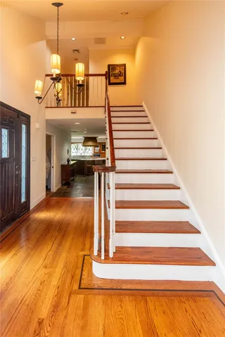 a view of entryway and hall with wooden floor