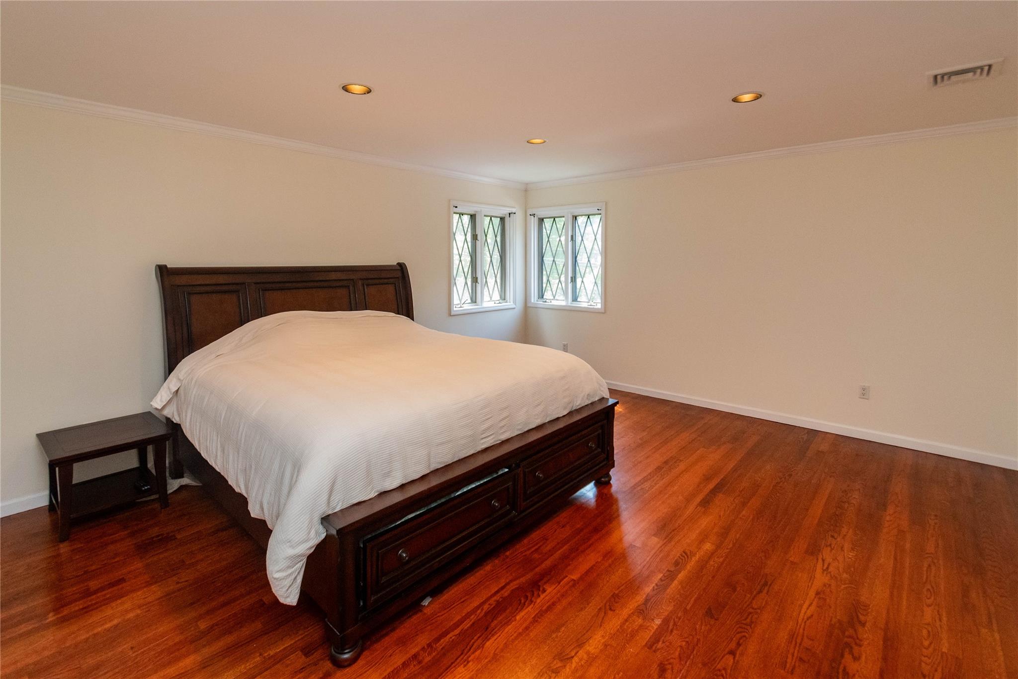 7 Fox Hollow Road Brewster, NY 10509 - Photo 26 of 33 a bed sitting in a bedroom next to a window with wooden floor