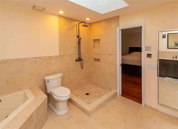 a bathroom with a toilet and a shower