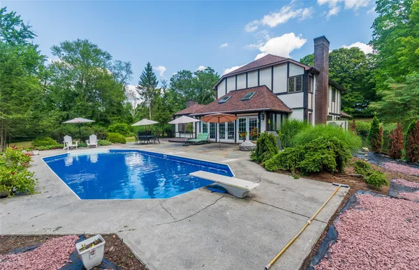 a view of swimming pool with outdoor seating and plants