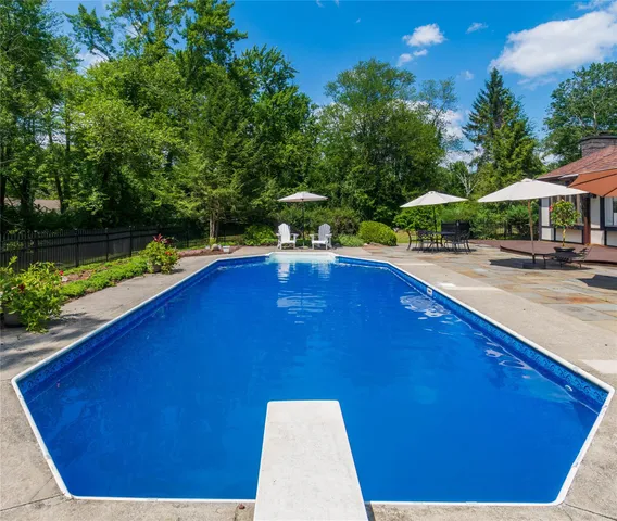 a view of outdoor space with pool and yard