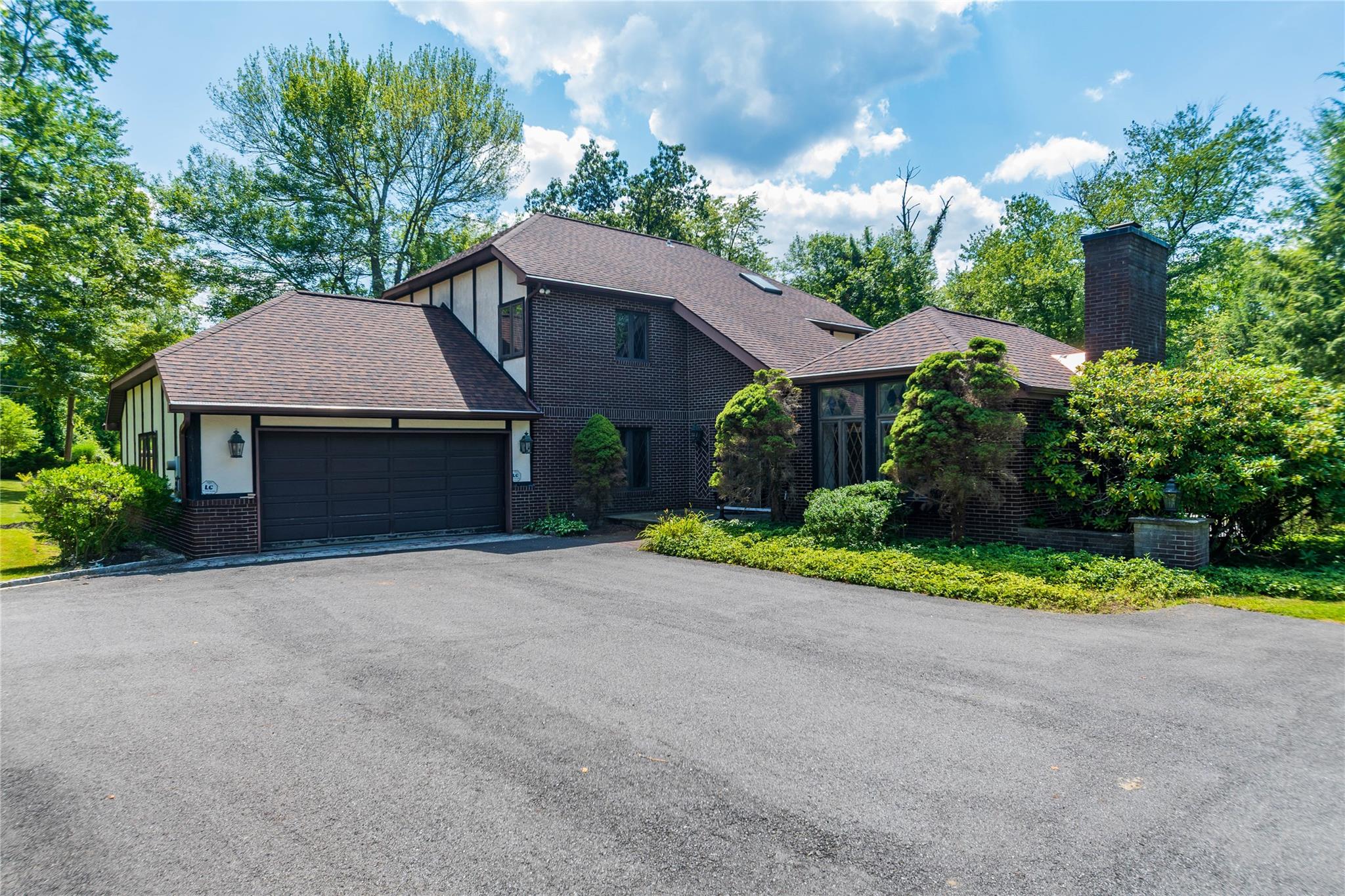 7 Fox Hollow Road Brewster, NY 10509 - Photo 8 of 33 a front view of a house with a yard and garage