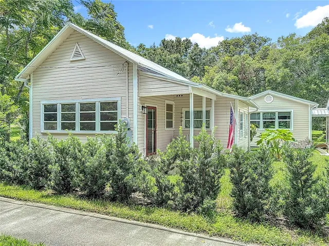 a view of a house with brick walls and flower plants