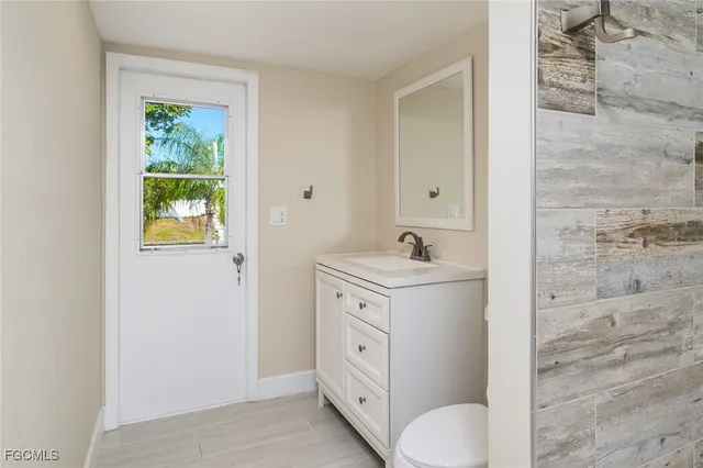 a spacious bathroom with a granite countertop sink toilet and shower