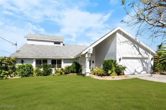 a front view of house with a garden