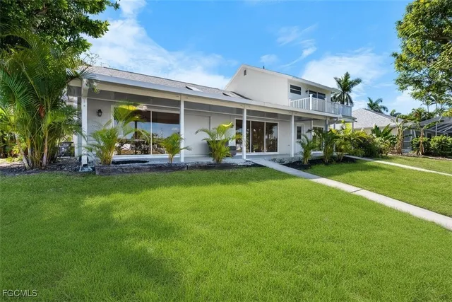 a front view of house with yard outdoor seating and green space