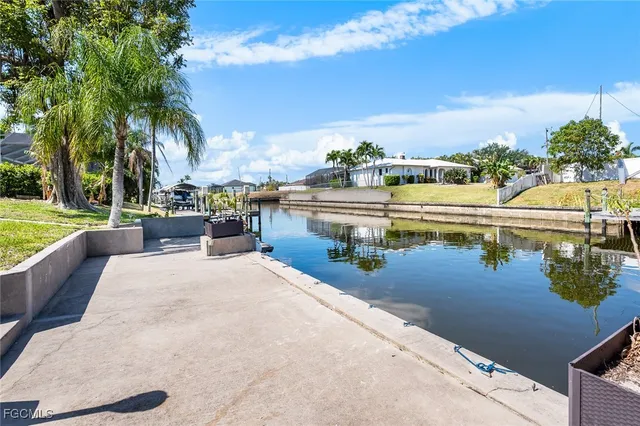 a view of a swimming pool with a lawn chairs under an umbrella