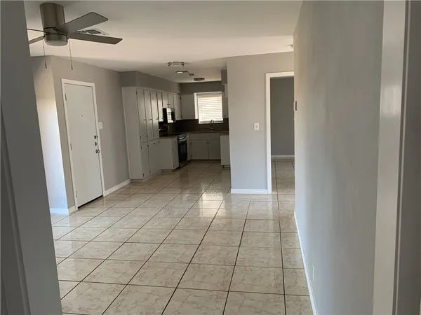 a view of a kitchen with a sink and a refrigerator
