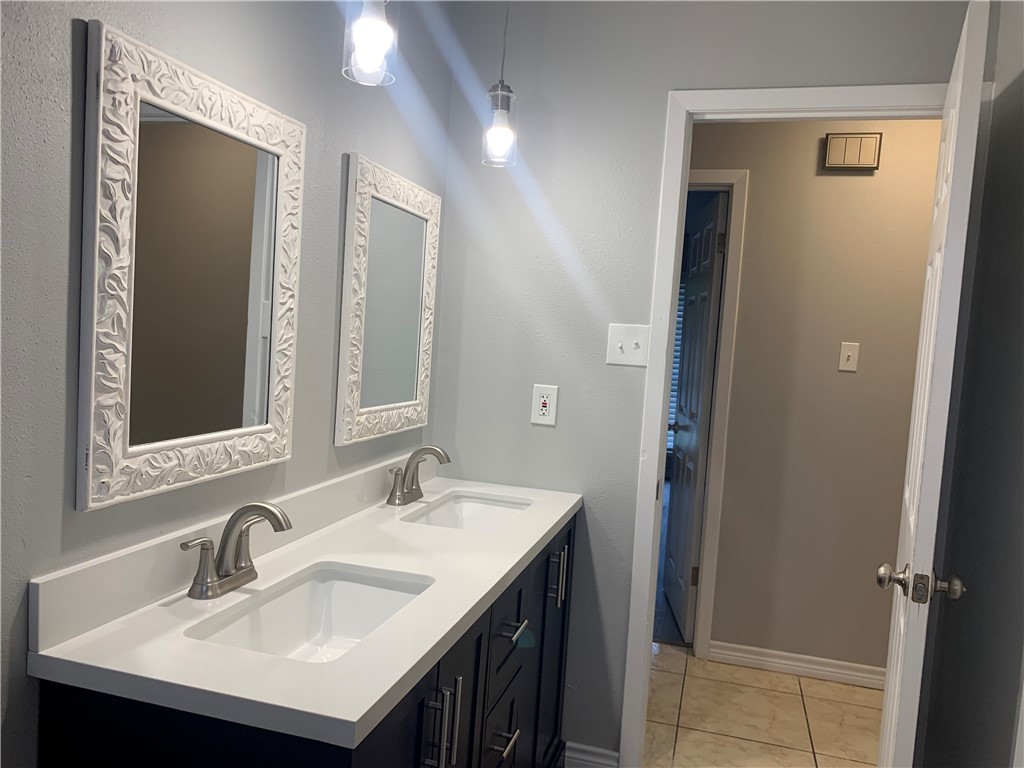1601 West Manor Drive Corpus Christi, TX 78411 - Photo 15 of 25 a bathroom with a sink and a mirror