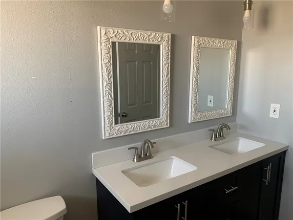 a bathroom with a toilet sink and mirror