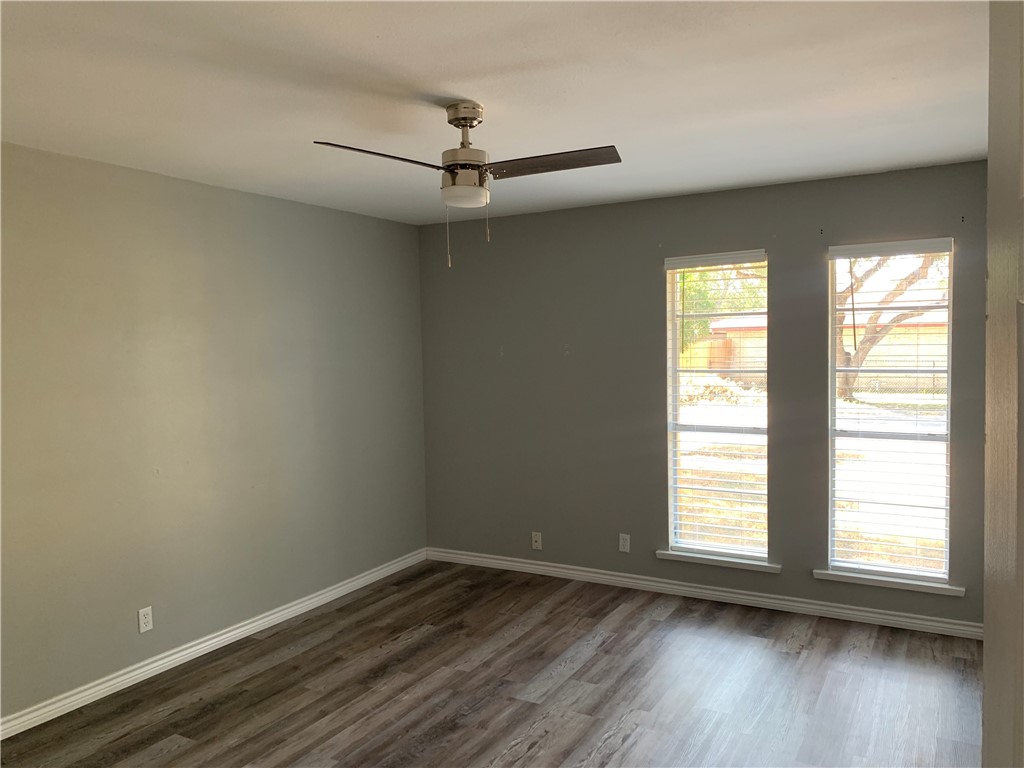 1601 West Manor Drive Corpus Christi, TX 78411 - Photo 18 of 25 an empty room with wooden floor fan and windows