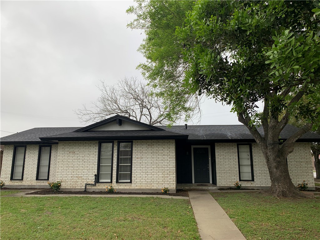 1601 West Manor Drive Corpus Christi, TX 78411 - Photo 3 of 25 a front view of a house with a yard