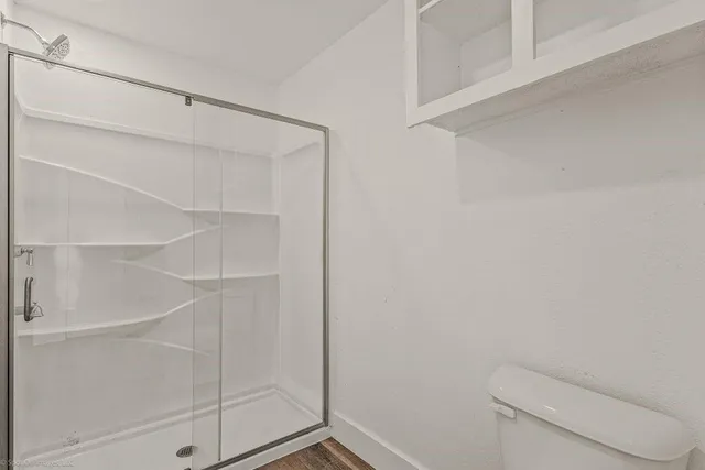 a bathroom with a toilet and shower