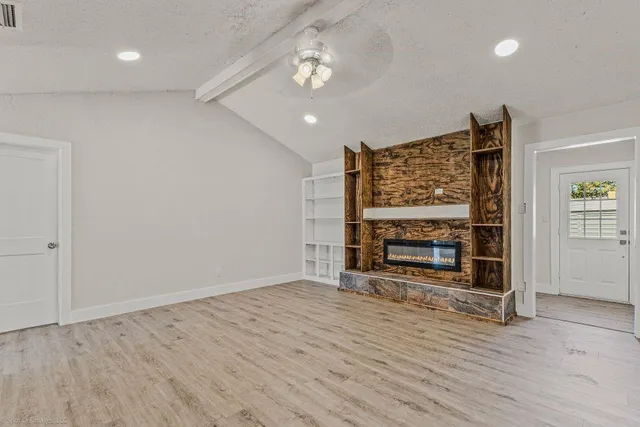 wooden floor in an empty room with a fireplace