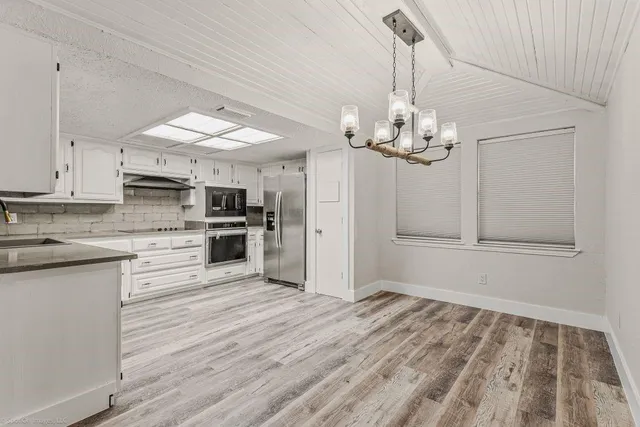 a view of a kitchen with microwave and stove top oven