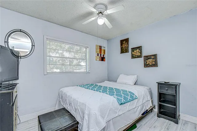 a kitchen with a sink dishwasher and a stove with white cabinets