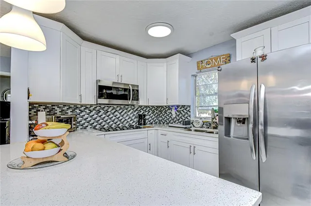 a front view of a livingroom with furniture and windows