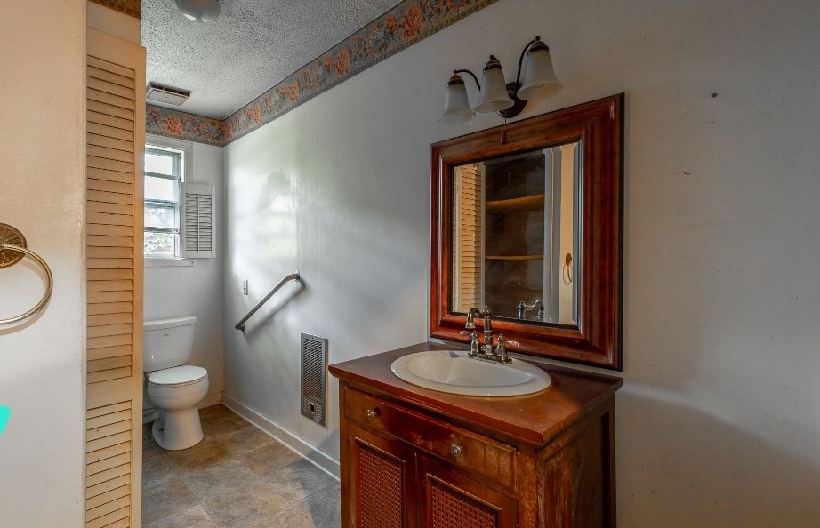 2419 Maple Street Chattanooga, TN 37406 - Photo 23 of 32 a bathroom with a sink a toilet and mirror