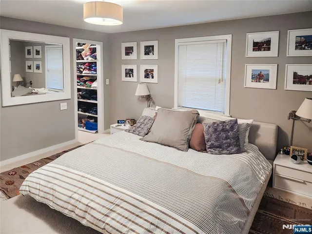 a bedroom with a large bed and a window