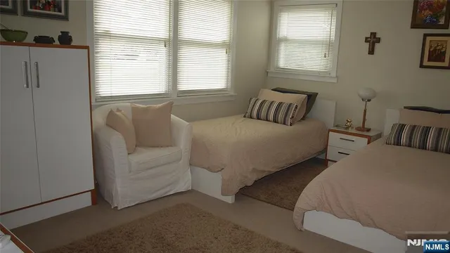 a bedroom with two beds and a window